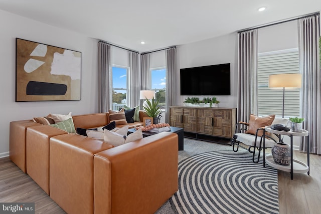 living area with light wood-style floors and recessed lighting