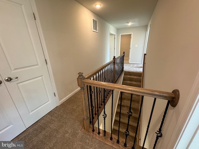 staircase with carpet, visible vents, and baseboards