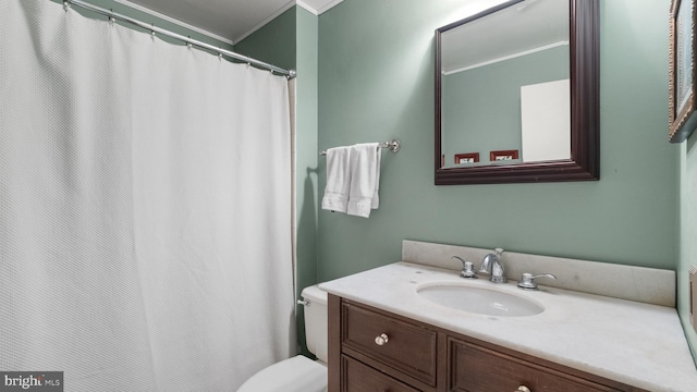 bathroom with vanity, toilet, and crown molding