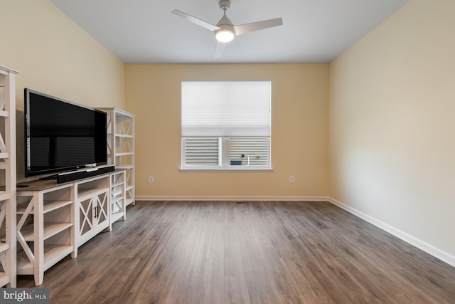 unfurnished living room featuring ceiling fan and dark hardwood / wood-style floors