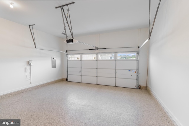 garage with electric panel and a garage door opener