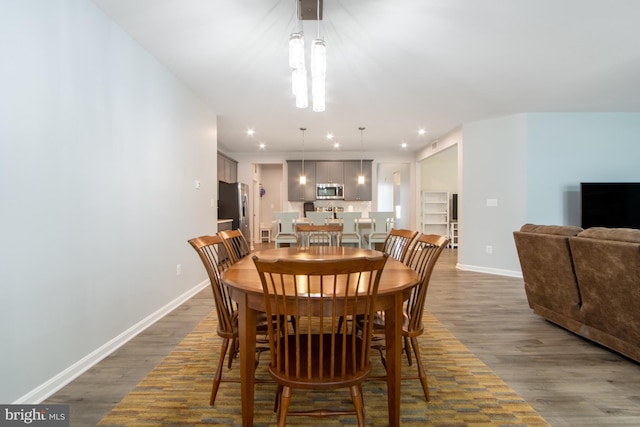 dining space with dark wood-type flooring