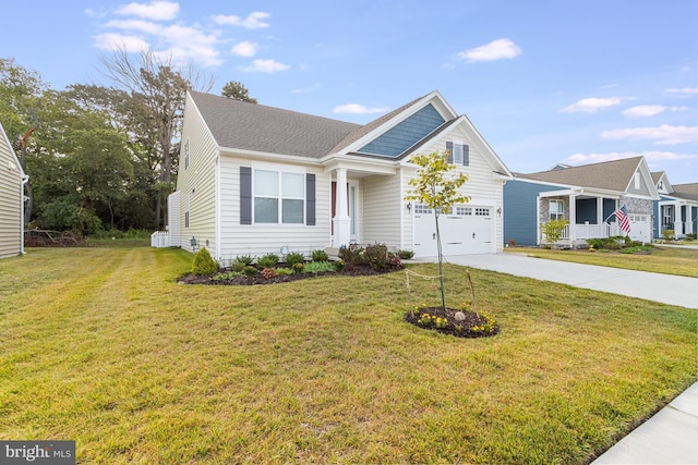 view of front of home with a front yard and a garage