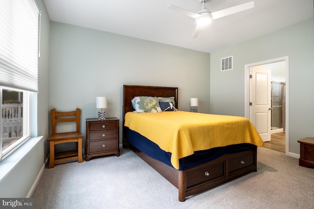 carpeted bedroom with ceiling fan and connected bathroom