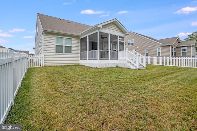 back of house with ceiling fan, a sunroom, and a lawn