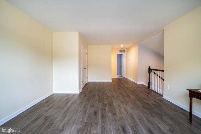 unfurnished room with dark wood-type flooring