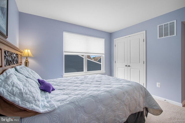 carpeted bedroom with a closet