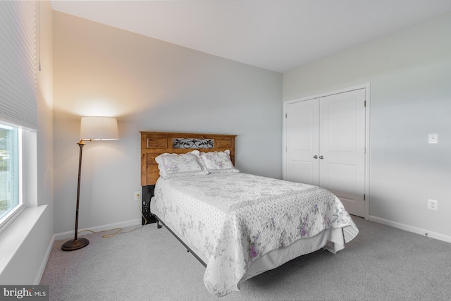 carpeted bedroom with a closet