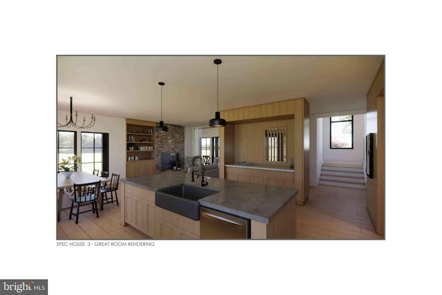 kitchen featuring sink, plenty of natural light, an island with sink, and dishwasher