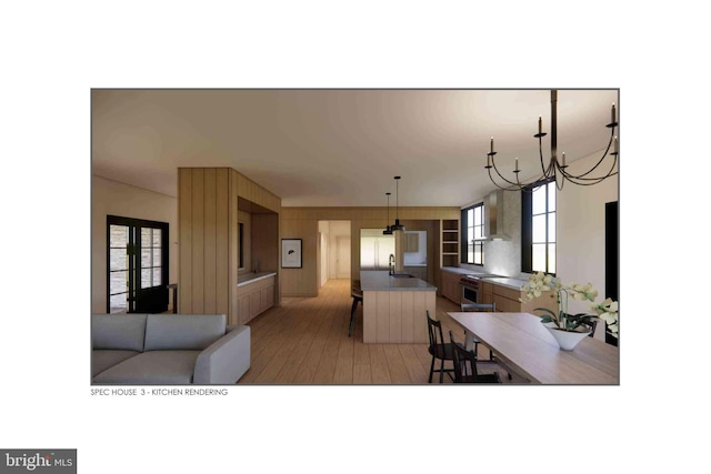 kitchen featuring sink, an inviting chandelier, white refrigerator, wall chimney exhaust hood, and light wood-type flooring