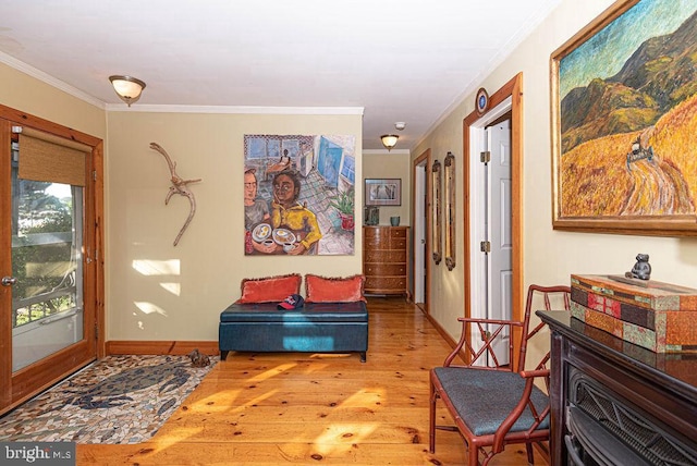 foyer entrance featuring ornamental molding and light hardwood / wood-style flooring