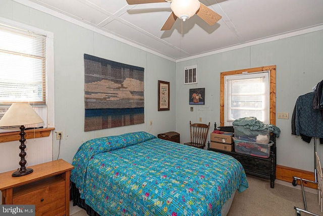 bedroom featuring carpet flooring, ceiling fan, crown molding, and multiple windows