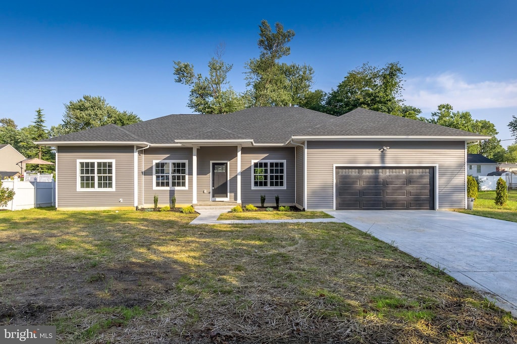 ranch-style home with a front yard and a garage