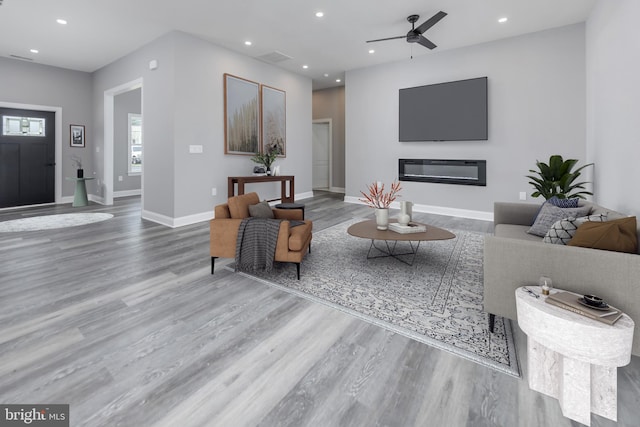 living room with hardwood / wood-style floors and ceiling fan