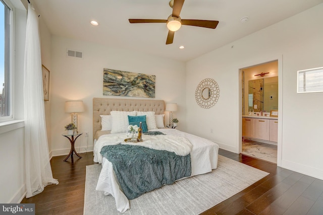 bedroom featuring ceiling fan, dark hardwood / wood-style floors, and connected bathroom