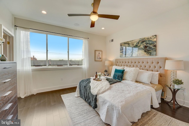 bedroom with dark hardwood / wood-style floors and ceiling fan