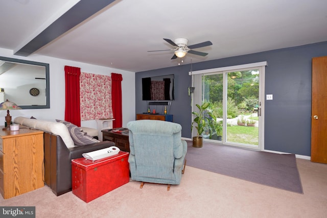 carpeted living room featuring beamed ceiling and ceiling fan