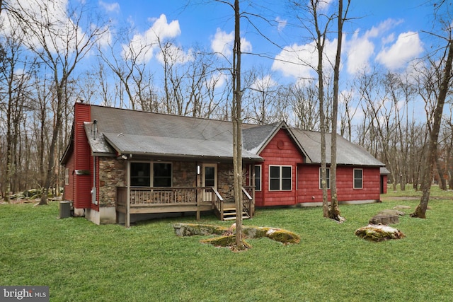 view of front of property with a front yard and cooling unit