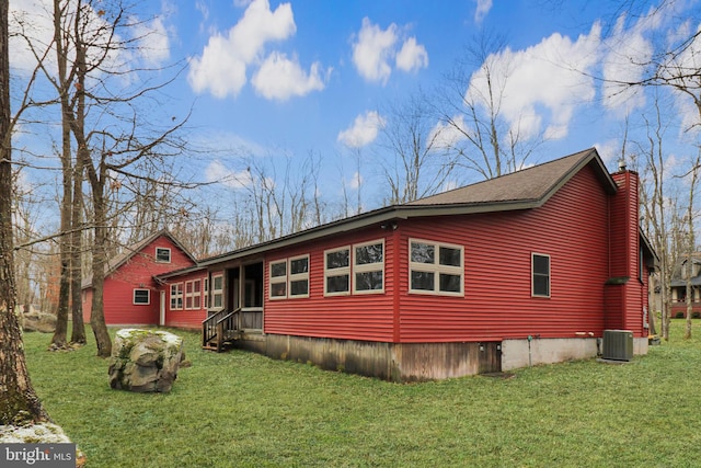 view of home's exterior featuring cooling unit and a yard