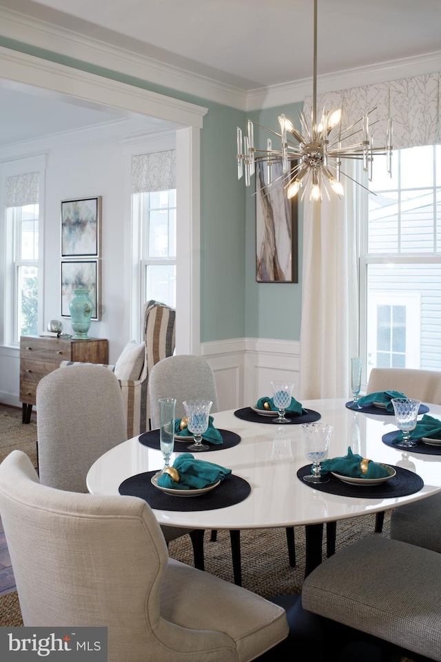 dining room with an inviting chandelier and ornamental molding