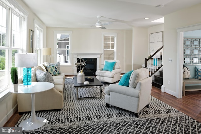 living room with hardwood / wood-style flooring and ceiling fan