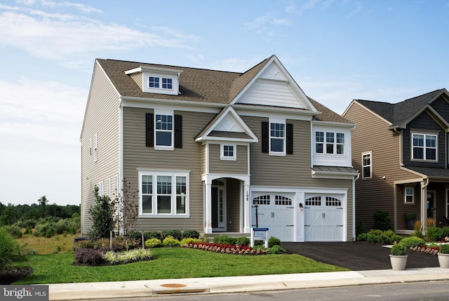 view of front of house with a garage and a front yard