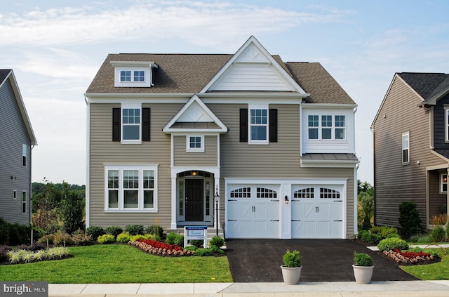 view of front of property featuring a front lawn and a garage