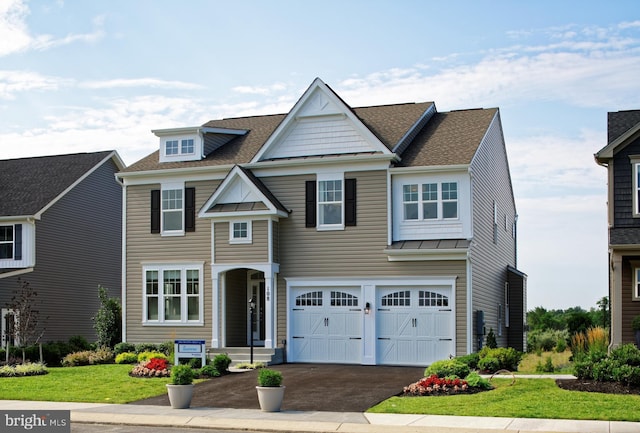 view of front of property with a garage and a front yard