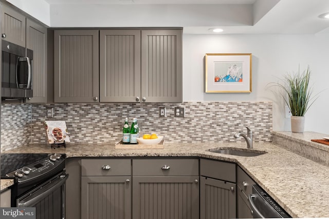 kitchen featuring appliances with stainless steel finishes, gray cabinetry, and sink