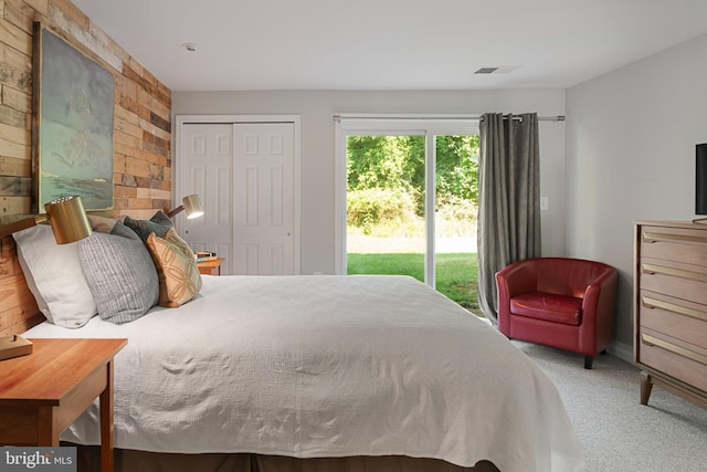 carpeted bedroom with a closet and access to outside