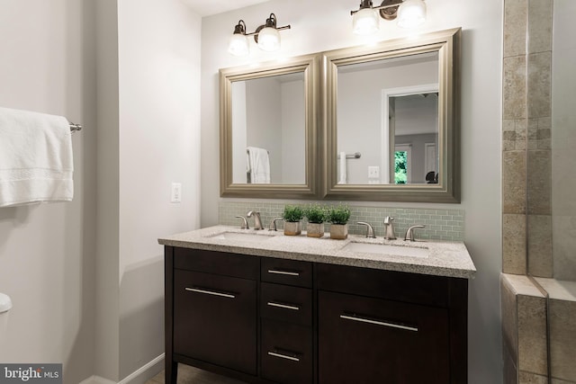 bathroom with tasteful backsplash and vanity