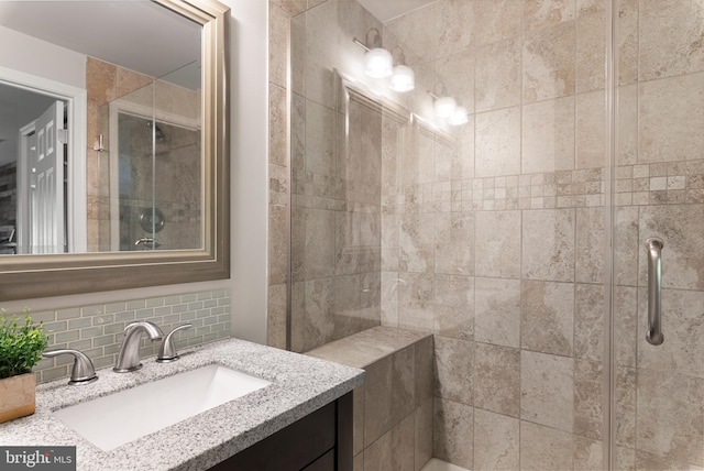 bathroom featuring decorative backsplash, walk in shower, and vanity