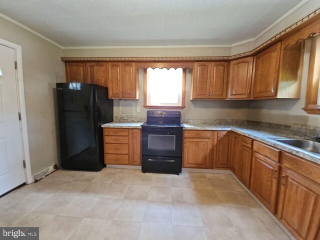 kitchen with sink, crown molding, black appliances, and light tile patterned floors