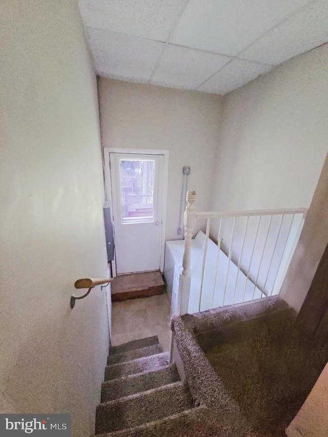 stairs featuring a paneled ceiling