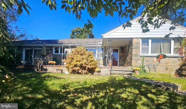 rear view of house featuring a lawn