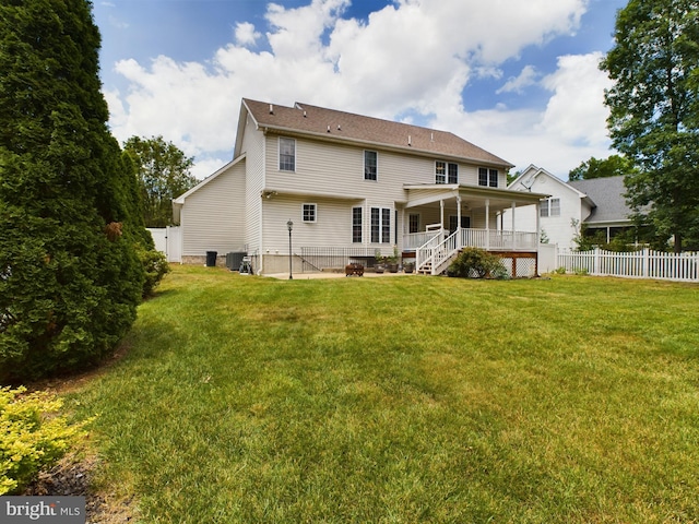 back of house with a yard and central AC unit