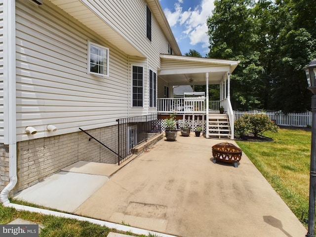 view of patio / terrace with a fire pit and ceiling fan