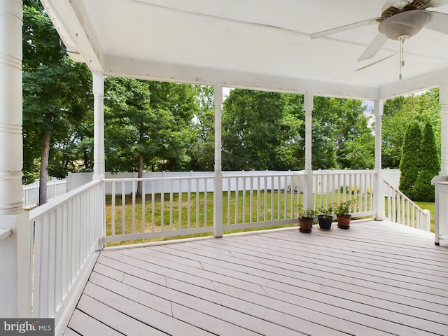 deck featuring ceiling fan and a yard