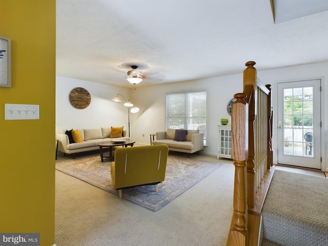 carpeted living room featuring ceiling fan