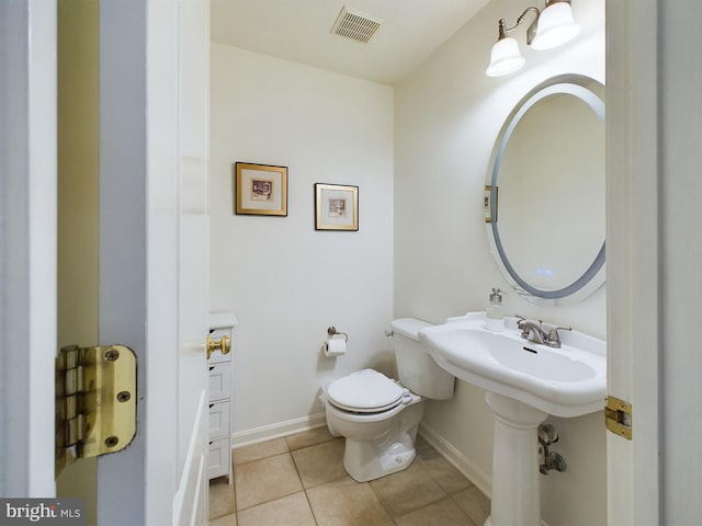 bathroom with tile patterned flooring and toilet