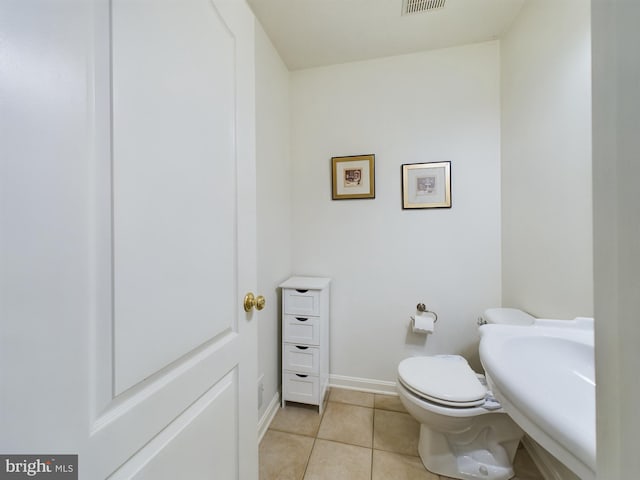 bathroom featuring tile patterned flooring and toilet