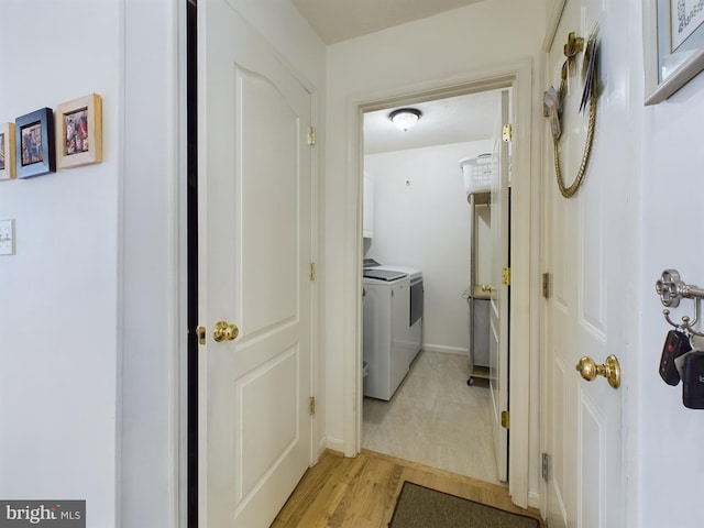 hall featuring separate washer and dryer and light hardwood / wood-style floors