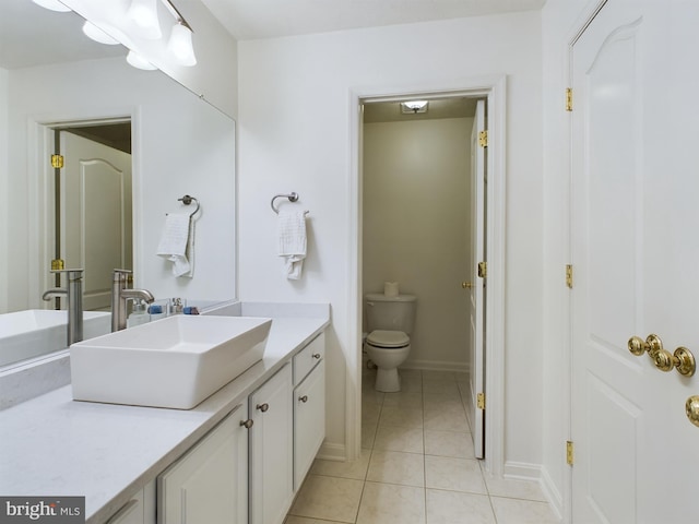 bathroom with tile patterned flooring, vanity, and toilet