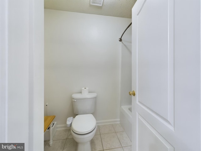 bathroom with tile patterned floors, toilet, and a textured ceiling