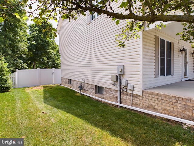 view of side of home with a lawn