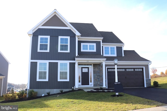 view of front of house with a garage and a front lawn