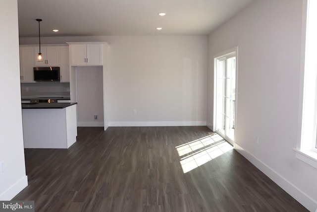 unfurnished living room featuring dark wood-type flooring