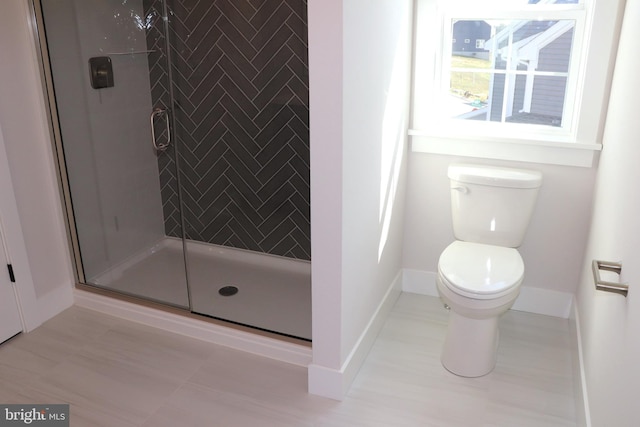 bathroom with tile patterned flooring, toilet, and walk in shower