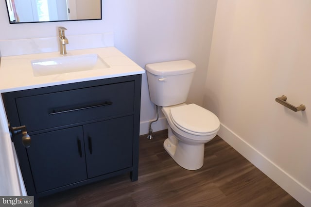 bathroom featuring hardwood / wood-style flooring, vanity, and toilet