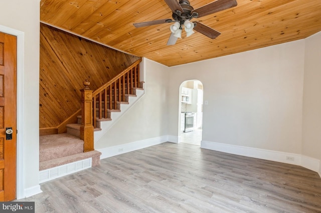 unfurnished living room featuring ceiling fan, hardwood / wood-style floors, and wooden ceiling